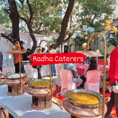 An outdoor buffet setup for a birthday party, showcasing our elegant copper serving dishes that keep the main courses perfectly warm.