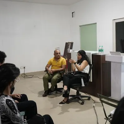 In conversation with emerging fashion models at a modeling agency, discussing the importance of understanding contracts and knowing their legal rights before signing any document.