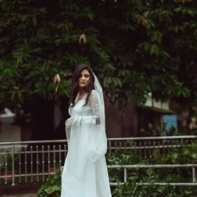 A portrait of bridal grace, with a flowing veil and a gown that tells a story of romance. I work with you to ensure every element of your attire and styling comes together perfectly.