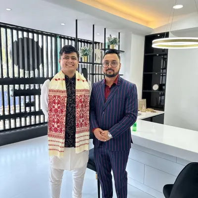 Posing with a client while wearing the traditional Assamese Gamusa. I believe in honoring local cultures and traditions in my work.