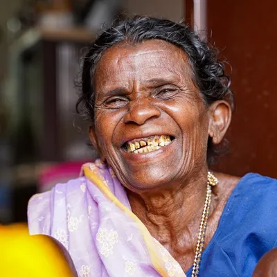 The incredible, heartwarming smile of an 'aaji' I met. This close-up shot in vibrant color captures the sheer happiness and life in her eyes, a moment of pure, unadulterated joy.