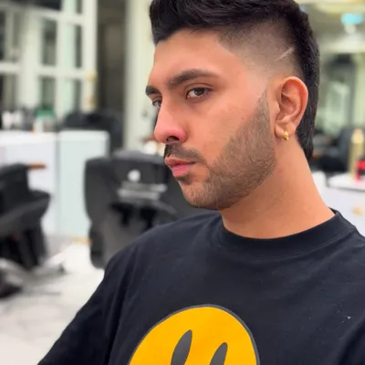 A different angle on this perfectly executed modern mullet. The fade is seamless, and the lines are razor-sharp, showing the precision I bring to every cut.