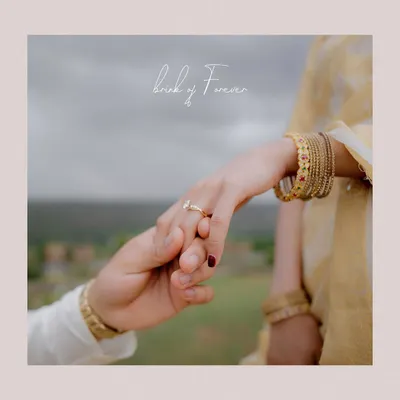 A close-up on the couple's hands as he places a ring on her finger, with the words "bond of forever" overlaid. This is a symbolic and beautiful detail shot.