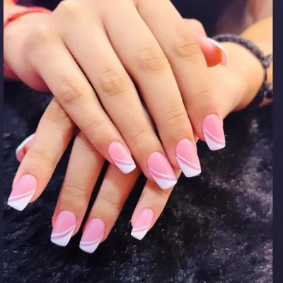 A perfect example of a modern classic. This design features a clean pink base with a sharp, angular white French tip for a contemporary look.