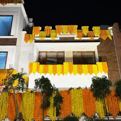 We gave this house a classic 'shaadi wala ghar' look with dense curtains of yellow and orange marigold garlands covering the entire facade.