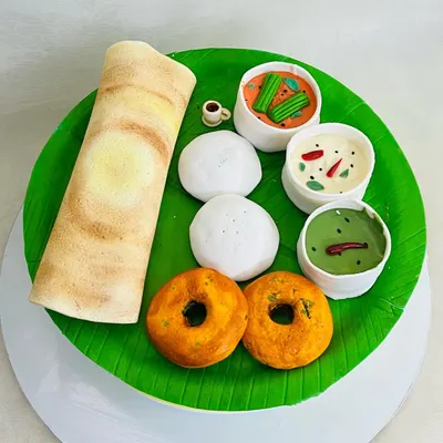 Is it breakfast or is it cake? This is a fully edible South Indian breakfast platter, complete with a dosa, idlis, vadas, and bowls of sambar and chutney, all made from fondant and cake.