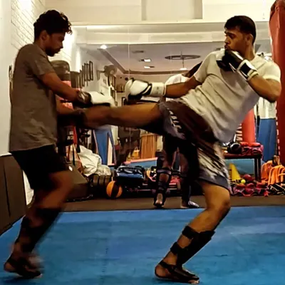 A strong kick starts with solid technique. Here, I'm sparring with a student at Ippon Institute, focusing on timing and distance for a body kick. We practice these drills to make our striking sharp and effective.