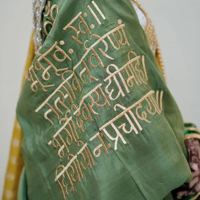 A close-up of the Gayatri Mantra beautifully embroidered onto the bride's blouse. We focus on these unique, personal details that make a bride's attire so special and meaningful.
