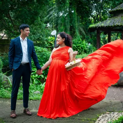 A walk in the park, but make it epic. The movement of this flowing red gown against the lush green backdrop creates such a dynamic and romantic photograph for this expecting couple.