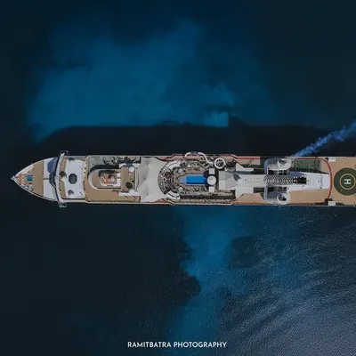 A stunning top-down drone shot of the Resorts World cruise ship sailing on the deep blue sea, showcasing the ultimate destination wedding venue.