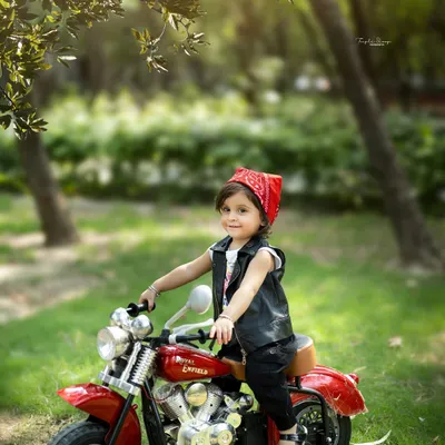 Taking the fun outside! This biker girl theme looks amazing in a natural park setting, creating a unique and adventurous portrait.