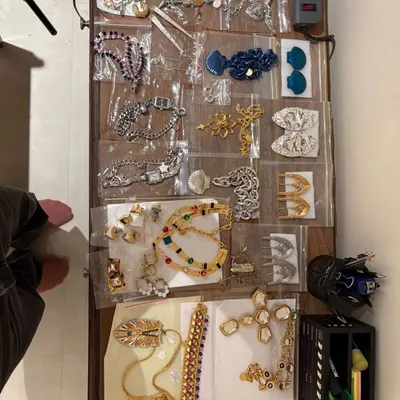 This is a snapshot of my styling kit in action. Every piece of jewelry is carefully selected and organized, ready to complete a look. Finding the perfect earrings, necklace, or bracelet is a crucial step in my creative process.