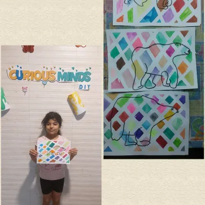 A proud student with her colorful cubism-inspired polar bear painting. Our Arctic Habitat session combined learning about geography with exploring different art styles, making the lesson multi-dimensional.