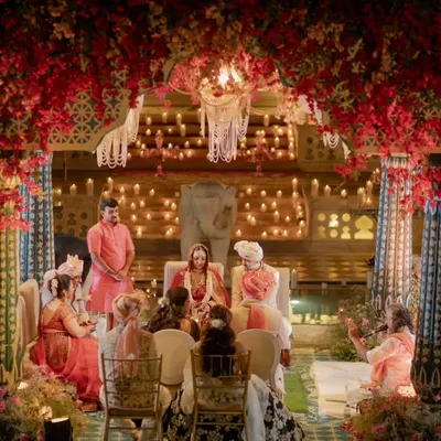 A mandap floating on water at Nahargarh Palace, designed for a moment of serene splendor. Under a canopy of red bougainvillea and the glow of countless candles, this setting was crafted to feel both regal and deeply intimate, a true sanctuary for sacred vows.