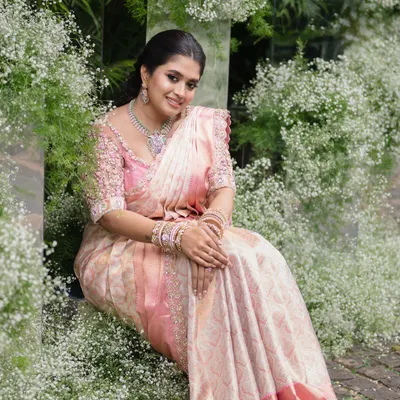 This client looks breathtakingly beautiful in her pastel pink saree for her engagement. I designed a matching blouse with 3D floral embroidery to create a look of modern romance.