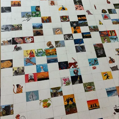 A wide shot of the mini-paintings canvas, showing the progress of filling up the grid with tiny, colorful artworks.