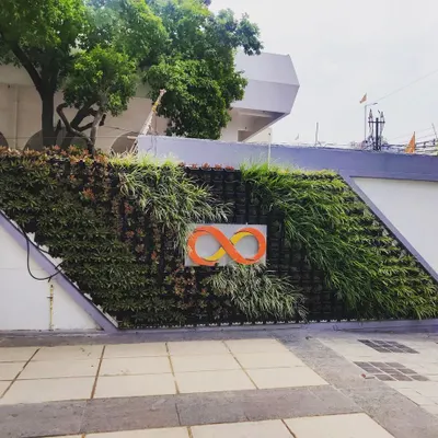 The completed vertical garden for Pantaloons in Patna. The brand's infinity logo is clearly visible, created using contrasting plants for a high-impact branding statement.