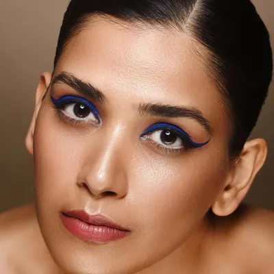 This clean beauty shot puts the focus squarely on the eyes. The sharp, electric blue eyeliner provides a pop of color against the model's natural skin tone, demonstrating my skill in capturing detailed makeup work for beauty campaigns or portfolios.