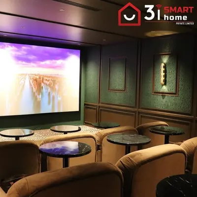 A view of the VIP client's cinema, where the large screen is flanked by elegant, textured wall panels and classic sconce lighting.
