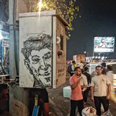 A spontaneous-looking sketch of a man's face drawn on a Mumbai City Surveillance utility box in Chembur. A great example of how even functional city objects become canvases.