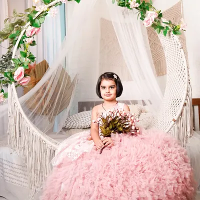 Your little girl can have her princess moment in this beautiful pink ruffled ball gown. This was shot in my studio's boho-chic setup with a hanging chair, creating a dreamy, fairytale look.