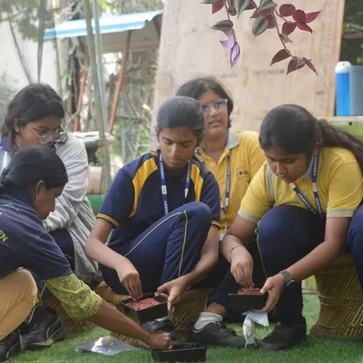 Students getting their hands dirty, learning to sow seeds during a school field trip. I believe these hands-on experiences are the best way to teach children about gardening.