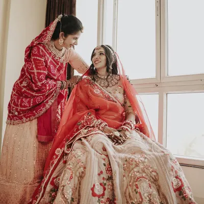 A heartwarming moment between the bride and her mother or sister. This candid shot captures the love and support of family on the wedding day.