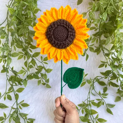 This life-sized crochet sunflower is almost 7 inches wide. Holding it up shows its impressive size and the detailed work that goes into each petal. It’s a statement piece all on its own.