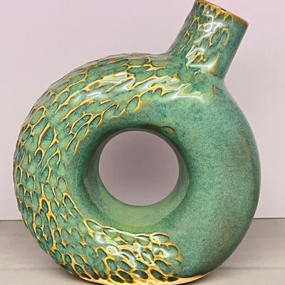 This textured turquoise donut vase is a real statement piece. The carving adds a beautiful tactile quality, and the shape is modern and sculptural.