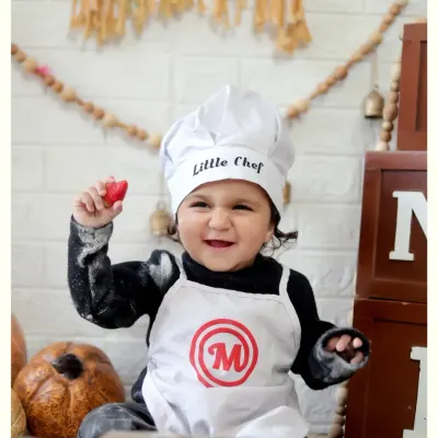 A joyful moment from our 'Little Chef' photoshoot. We use fun props like flour and rolling pins to create an interactive and delightful experience for your child.