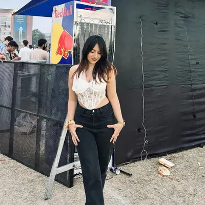 A cool and casual look featuring a white corset top from NewMe at a Red Bull event. This shows how I style trendy pieces for everyday events.