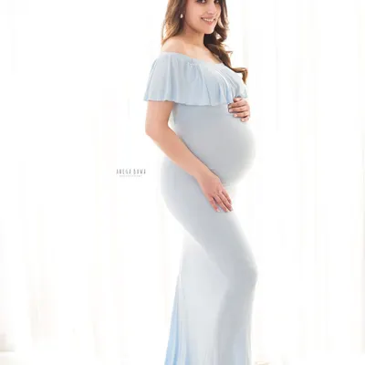 A classic solo maternity portrait using soft, beautiful window light. The light blue gown from my studio collection complements the bright and airy aesthetic perfectly.