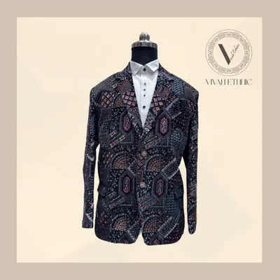 This one-of-a-kind blazer is designed to steal the spotlight. The carnival-themed embroidery on a dark base makes it a truly unique piece for a man with bold style.