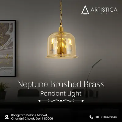 The Neptune Brushed Brass pendant features a classic bell-shaped amber glass shade that encases three candle-like bulbs. This fixture provides a warm, inviting glow and adds a touch of timeless elegance to any room.