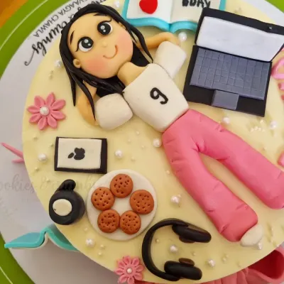 This cake is a perfect match for the birthday girl's hobbies. I created fondant versions of her laptop, headphones, cookies, and even a little book to capture her personality in edible form.