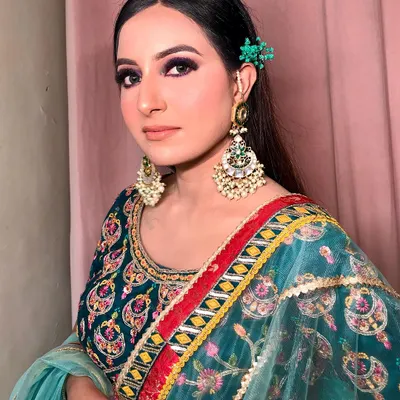 A bold and beautiful look featuring a deep purple smokey eye. I balanced the strong eye makeup with a neutral lip and softly flushed cheeks, making it a perfect statement look for a Mehendi or Sangeet function.