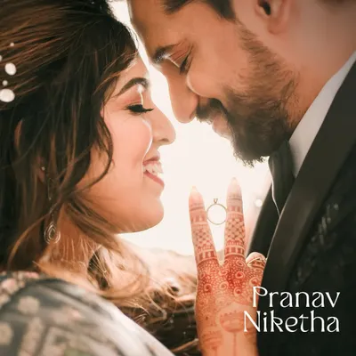 A beautiful backlit close-up focusing on the couple's connection and the engagement ring. This creative shot is a perfect way to highlight the details of your love story.