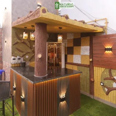 The unique, custom-designed outdoor bar at our completed Shahdara project, featuring a tree-like support column and textured walls.