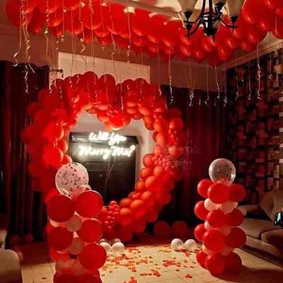 Creating a magical proposal moment is my specialty. This setup features a floor-to-ceiling balloon arrangement, including a large heart arch that perfectly frames the 'Will you Marry Me?' neon sign for an unforgettable memory.