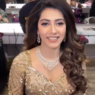 A smiling model wearing a delicate American Diamond necklace set. This elegant and understated piece is perfect for a reception or engagement party.