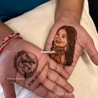 This is what I mean when I say let's make your mehendi personal. I created this detailed portrait of the bride on the groom's palm, a truly modern groom mehendi idea that was such a special surprise for her. On the other hand, we have his bride's initial 'M' inside a delicate wreath.