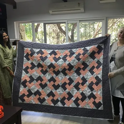 Two of our wonderful clients proudly displaying the beautiful geometric quilt they created. We were so happy to provide the longarm quilting to finish their masterpiece.