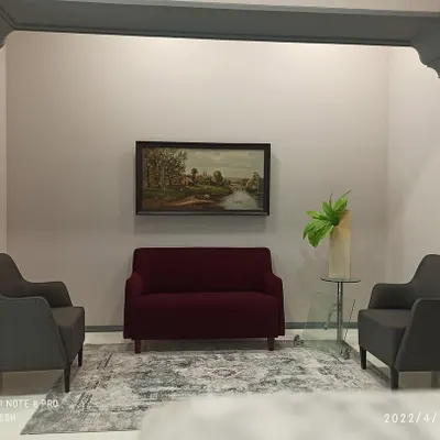 The reception area at Shiva Group's head office, designed to make a lasting first impression. I used custom grey mouldings to create a classic archway, framing a comfortable and elegant seating arrangement. This space balances professional decor with a welcoming atmosphere for visitors.