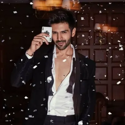 Styling Kartik Aaryan for a Bombay Times feature. This shot captures a playful yet sophisticated vibe with a velvet tuxedo jacket and confetti, creating a celebratory mood for the "Freddy" movie promotion.