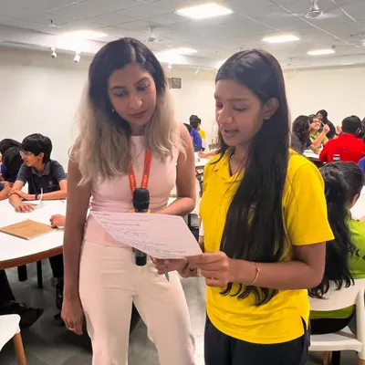 Our founder mentoring a student at Prometheus School during a poetry workshop. We provide one-on-one guidance to help young writers find their voice.