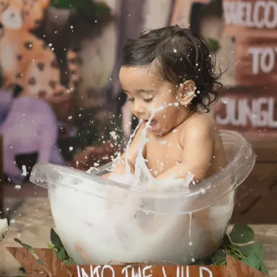 A huge splash in the tub. This action shot from our jungle-themed milk bath captures the pure, messy fun of the session.