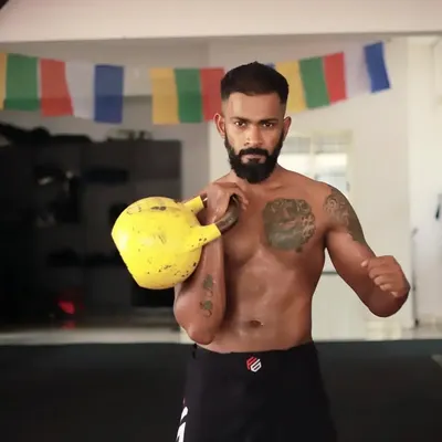 Being in fighting shape is a state of mind. Here I am with a kettlebell, a key tool in our strength and conditioning programs that build the physical resilience needed for combat sports.