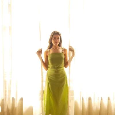 Using the soft, diffused light from a sheer curtain to create a dreamy and ethereal portrait. This is a simple but very effective technique for indoor shoots.