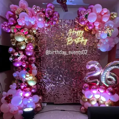 A full view of our stunning rose gold sequin wall, framed by an elaborate balloon garland in shades of pink, purple, and gold. This setup for a 26th birthday is pure glamour.