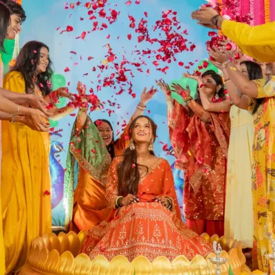 A moment of pure joy, showered in love and petals. I created this vibrant setting with a golden lotus seat for the bride, making her the radiant center of her Mehndi celebration.